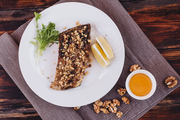 fried dish made of breaded river fish fillet Carp served on a plate at a restaurant