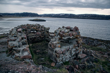 Stone defense on a rocky seashore. Barents Sea Arctic Circle.