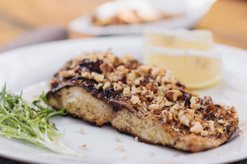 fried dish made of breaded river fish fillet Carp served on a plate at a restaurant