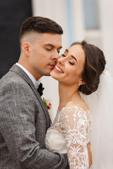 Happy newlyweds. Beautiful wedding couple in love. Bride and groom kisses with smile