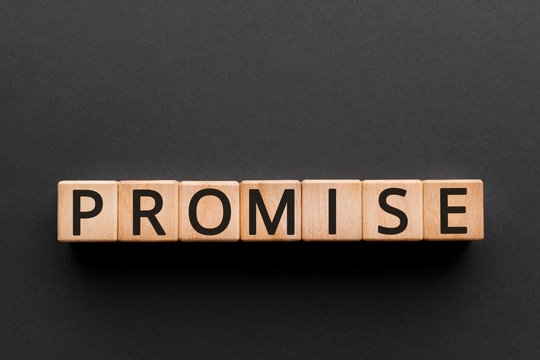 Promise - word from wooden blocks with letters, a javascript object promise concept, black background