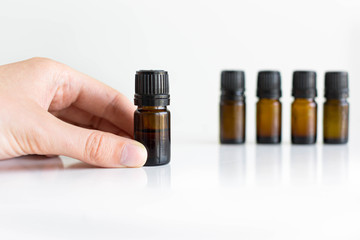 Bottles of essential oils display. White background. Natural health and medicine.