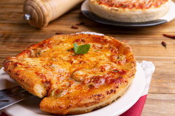 Chicago Style Deep Dish Cheese Pizza with Tomato Sauce, on wooden background