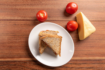 Sandwich with cheese and tomato, on wooden background