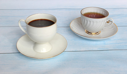 Cup of fresh coffee on blue wooden background, top
