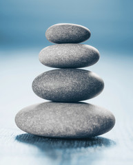 Fototapeta na wymiar Stack of Zen Stones on blue background.