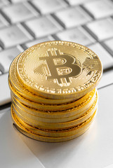 Golden Bitcoin coins on the laptop