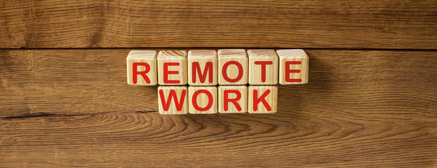 Concept words remote work on cubes on a beautiful wooden table.