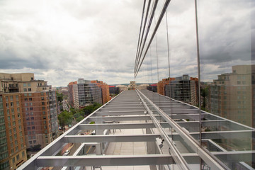 Railroad track perspective from a rooftop reflecting a mirrored office building