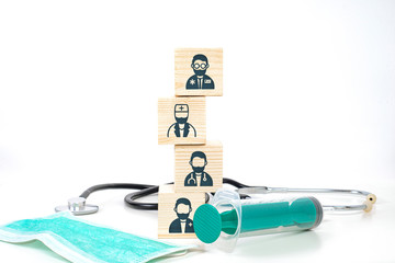 Icons of doctors on wooden blocks and medical. Medical and pharmaceutical concept. The fight of doctors for human life, the dedication of medical staff in the fight against viruses, bacteria, germs.