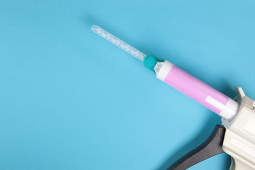 Fototapeta premium Dental gun on a blue background.