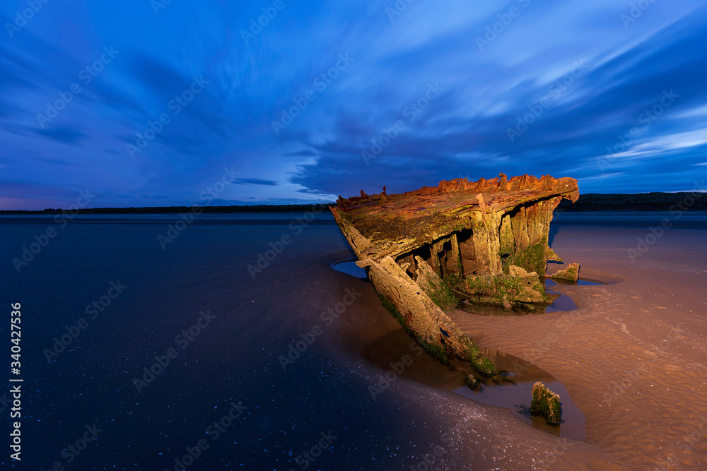 Wall mural shipwrecked off the coast of ireland, an shipwreck or abandoned shipwreck,,boat wreck sunset light a