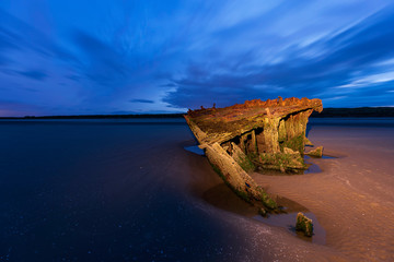 Shipwrecked off the coast of Ireland, An shipwreck or abandoned shipwreck,,boat Wreck Sunset light...