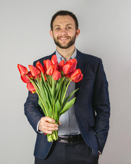 a young man with red flowers