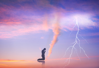 Fototapeta na wymiar Man praying in front of the natural phenomenon