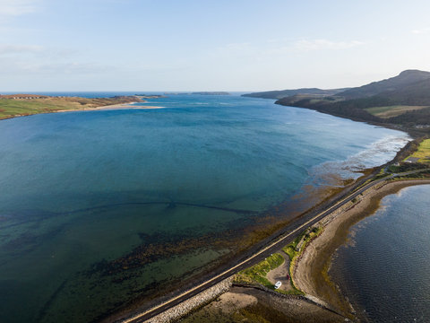 Aerial drone photo of Kyle of Tongue which is a shallow sea loch in northwest Highland, Scotland, in the western part of Sutherlan. Cars standing on a parking near road.