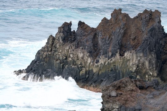 brown rock in the turoquois sea