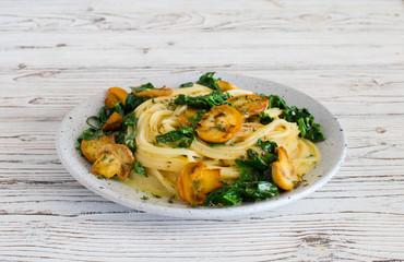 Italian pasta with fried  mushrooms and spinach closeup
