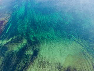 Aerial drone photo of 
a beautiful water of Atlantic Ocean with turquoise water. Vertical drone look.