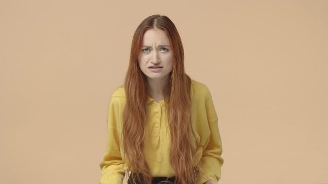Relationship, emotions concept. Distressed, frustrated and upset young redhead woman asking why, shouting at person lied her, shaking hands need answer, having fight, angry about something
