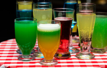 Glasses with a cocktail. Multicolored drinks. Drunk party.