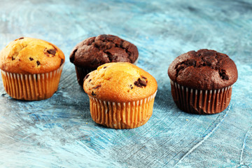 Chocolate muffin and nut muffin, homemade bakery on background.