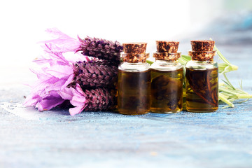 Obraz na płótnie Canvas lavender herbal oil and lavender flowers. bottle of lavender massage oil for aromatherapy treatment