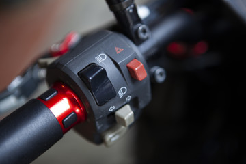 Macro detail of light and horn switches in a naked motorcycle