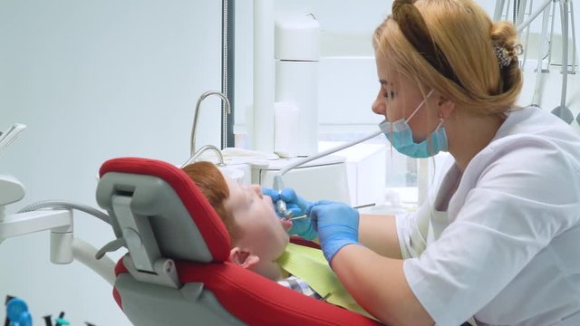 A little boy having a teeth cleaning treatment in the dentistry