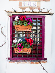 Typical facade with barred window and flowers from Denia, Alicante, Spain