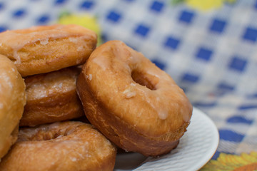 glazed donuts on a white plate, close-up