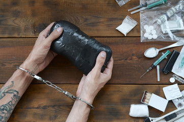Drug trafficker arrested with their heroin packages. Police arrest drug dealer with handcuffs and...