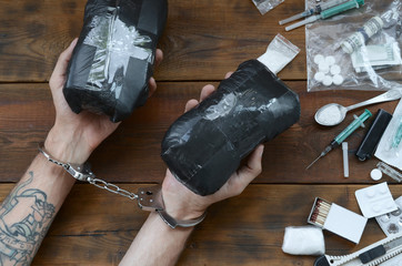 Drug trafficker arrested with their heroin packages. Police arrest drug dealer with handcuffs and...