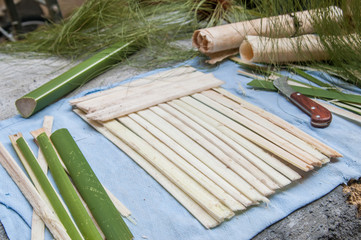 The making of papyrus paper: Strips obtained from the stem of a plant with a typical knife 