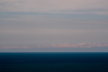 View of the foothills of the Caucasus. District of the city of Batumi. At the high peaks lies snow. On the lower mountains are residential buildings. The terrain has a different color.