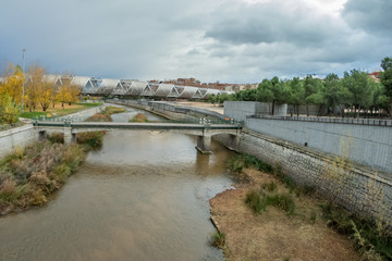 MADRID, SPAIN - DECEMBER 13, 2018: The Arganzuela bridge over Manzanares River downtown Madrid, Spain. It is a futuristic structure built in 2011. Super wide angle panorama