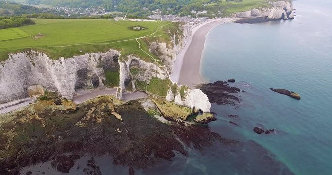 cliffs of Etretat in Normandy, France. Cliffs white work of nature, drone photos, camera movement to the side, view of golf courses, rocks, beaches and sea, shot in the early day, summer. 4k25ftp