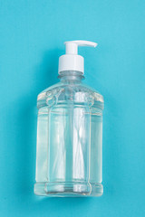 Container with alcohol gel on the light blue background