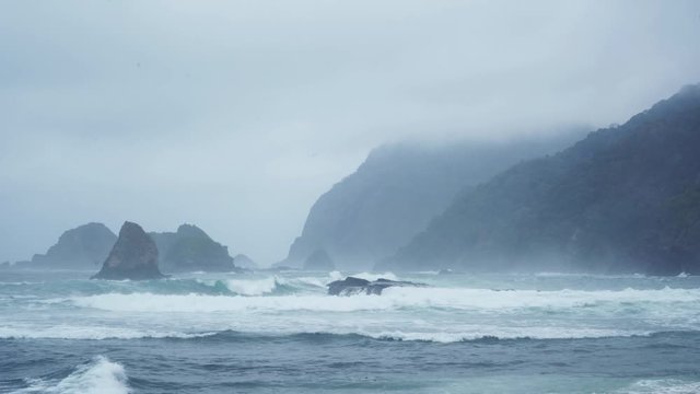 Exotic scenery of Papuma beach with rocks covered by foggy in Jember at East Java, Indonesia. Shot in 4k resolution