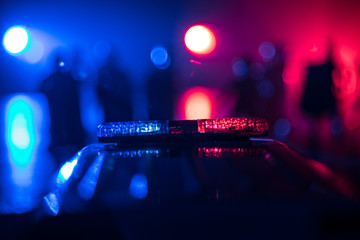 Police cars at night. Police car chasing a car at night with fog background. 911 Emergency response police car speeding to scene of crime. Selective focus