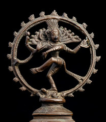 Bronze statue of the Hindu god Shiva  isolated on black. Shiva represents death and dissolution,...