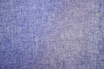 Blue denim background, jeans close-up texture. Rough blue fabric, close-up cloth textile background