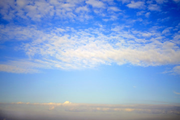 Feather and cumulus clouds on the sky, background, copy space for text