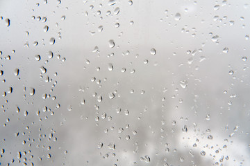 Water drops on the window, glass background in rainy weather