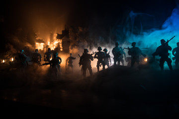 Naklejka na ściany i meble War Concept. Battle scene on war fog sky background, Fighting silhouettes Below Cloudy Skyline at night.
