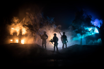 Naklejka na ściany i meble War Concept. Military silhouettes fighting scene on war fog sky background, World War Soldiers Silhouette Below Cloudy Skyline At night.