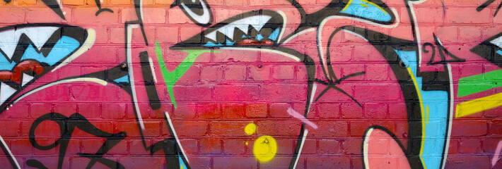 Abstract colorful fragment of graffiti paintings on old brick wall. Street-art composition with...