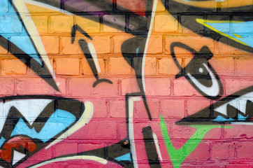 Abstract colorful fragment of graffiti paintings on old brick wall. Street art composition with...