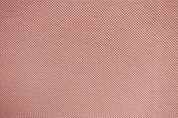 Fototapeta premium Texture of red fabric with a repeating uniform pattern of dots