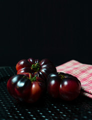 Tomatoes on black plate and napkin